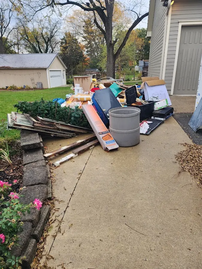 Dumpster being loaded with debris for Estate Cleanout Dumpster Rental in Johnson City